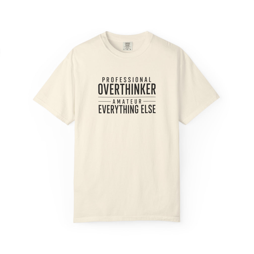 A beige short sleeved t shirt with the words Professional Overthinker, Amateur Everything Else.