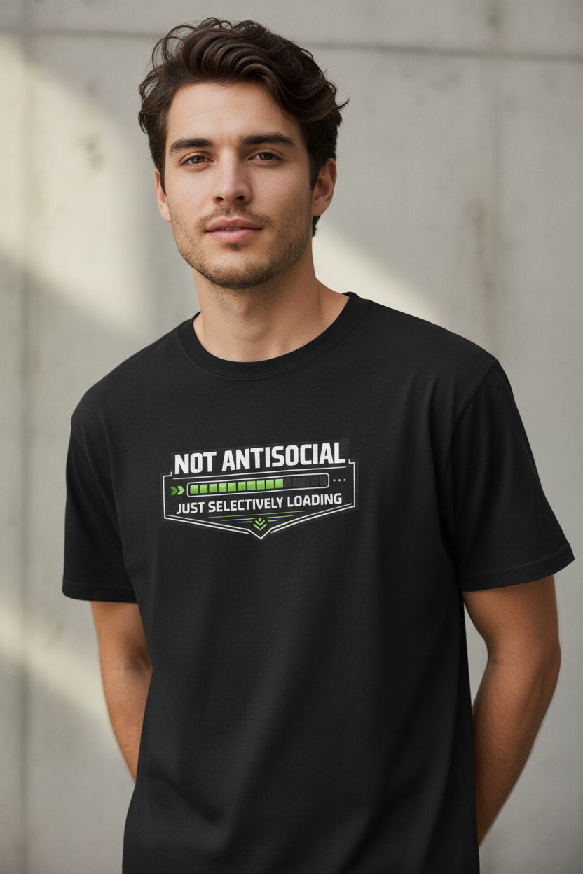 A man wearing a black t-shirt with a graphic that reads 'NOT ANTISOCIAL JUST SELECTIVELY LOADING' in white and green, set against a concrete wall background.

Details