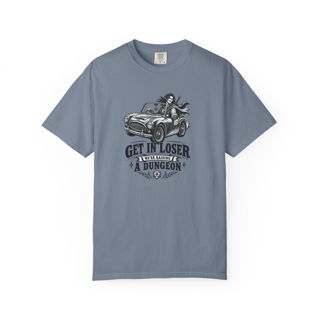 a slate blue t shirt with a black and white design of an elf gamer sitting in a convertible with the word Gei In Loser We're raiding a dungeon  against a white background