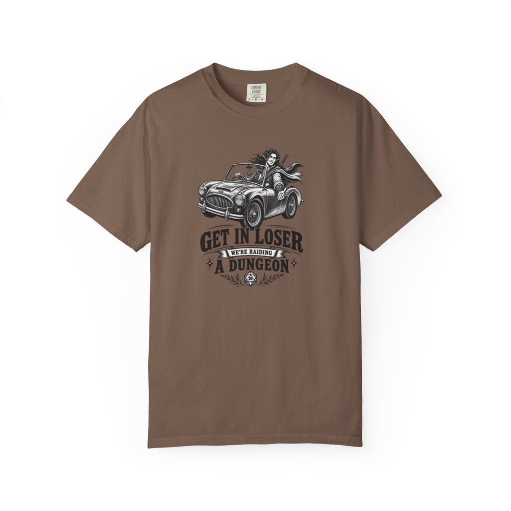 a brown t shirt with a black and white design of an elf gamer sitting in a convertible with the word Gei In Loser We're raiding a dungeon  against a white background
