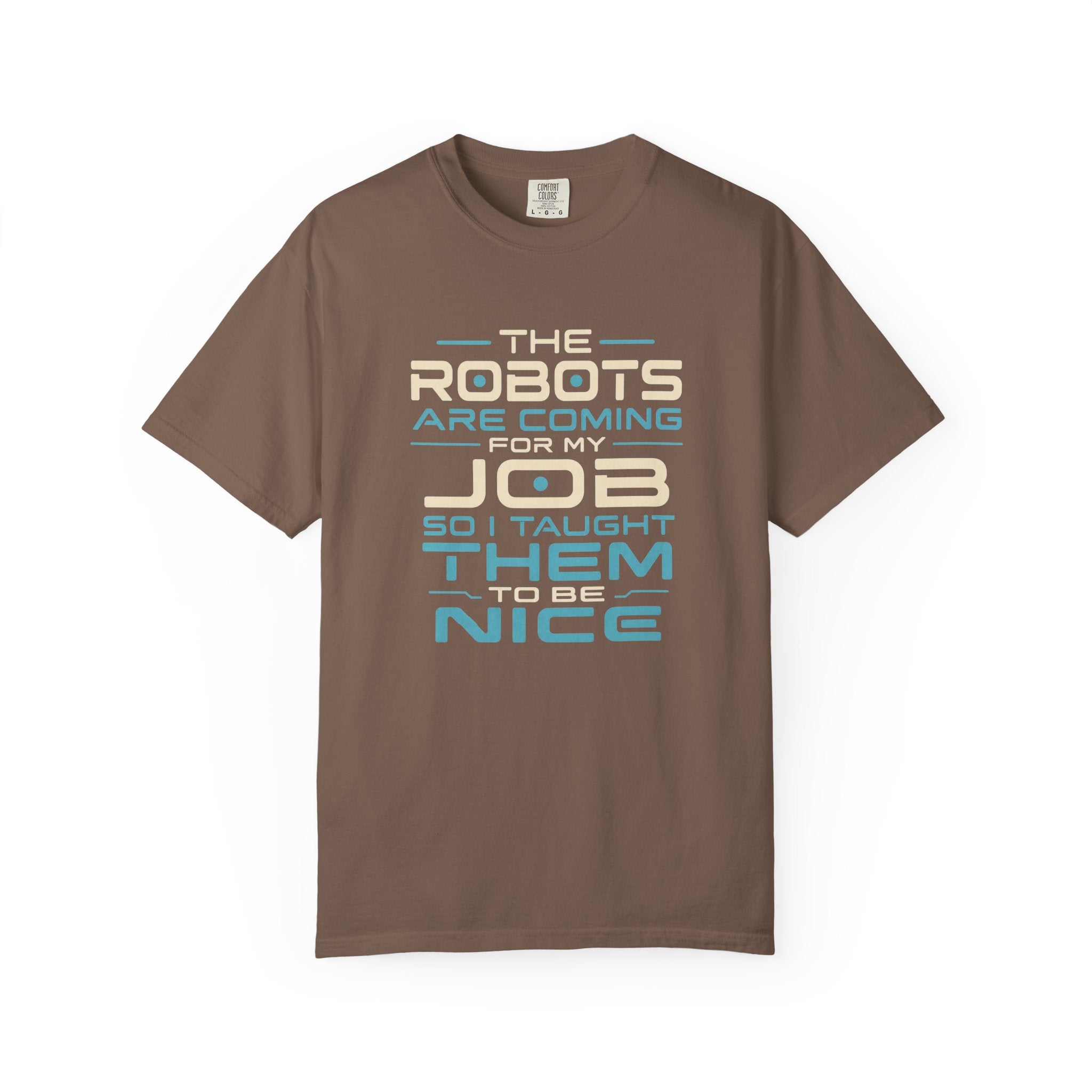 A brown short-sleeve crewneck t-shirt with a retro-style text graphic on the chest that reads 'THE ROBOTS ARE COMING FOR MY JOB SO I TAUGHT THEM TO BE NICE' in beige and light blue lettering, displayed on a clean white background.