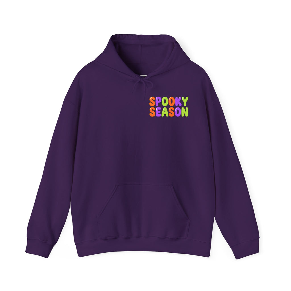 A purple pullover hoodie with a colorful graphic on the chest that reads 'SPOOKY SEASON' in a rainbow gradient font, displayed against a solid white background.