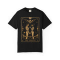 A black Comfort Colors t-shirt featuring The Lovers from the Future Arcana collection, inspired by The Lovers tarot card. Two futuristic figures stand together beneath a radiant celestial sky, framed by elegant Art Deco details in gold line art on a transparent background.