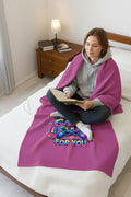 Pink blanket with colorful text and gaming controller graphic on a bed
