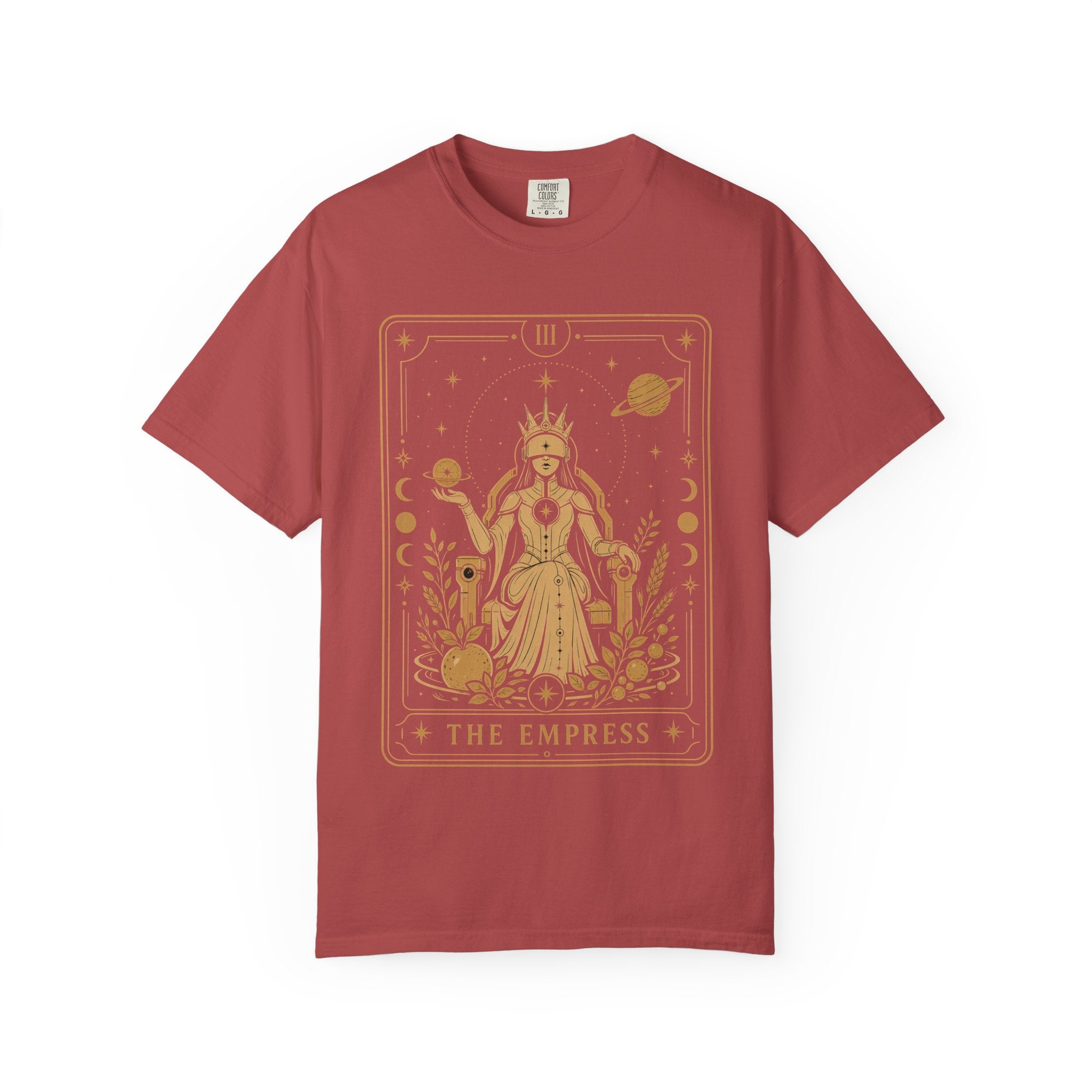A short-sleeve crewneck t-shirt in a muted brick red color, featuring a large gold tarot card graphic of 'The Empress' on the front, displayed against a clean white background.