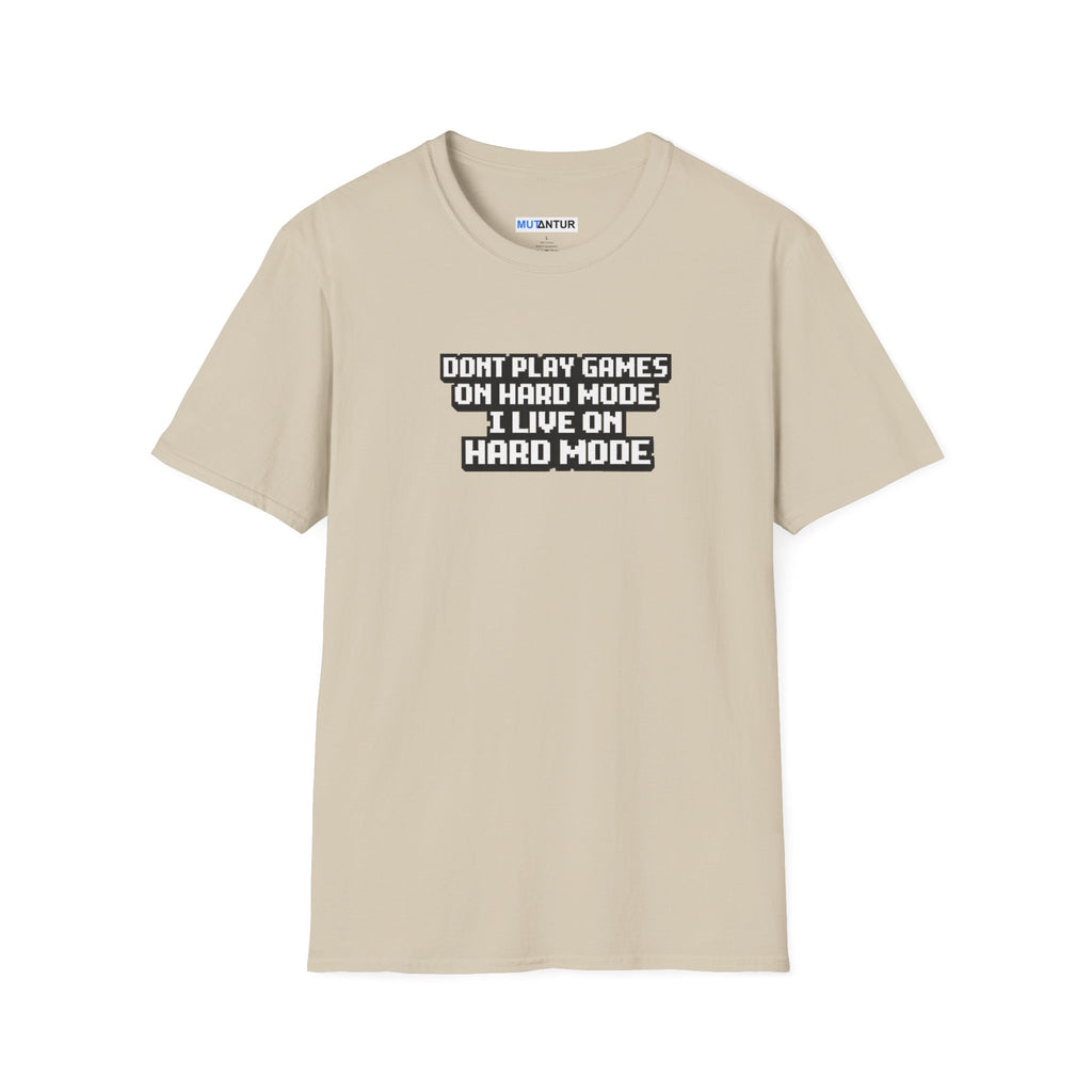 A beige crewneck t-shirt with a black and white graphic text print on the chest that reads 'DONT PLAY GAMES ON HARD MODE I LIVE ON HARD MODE'.
