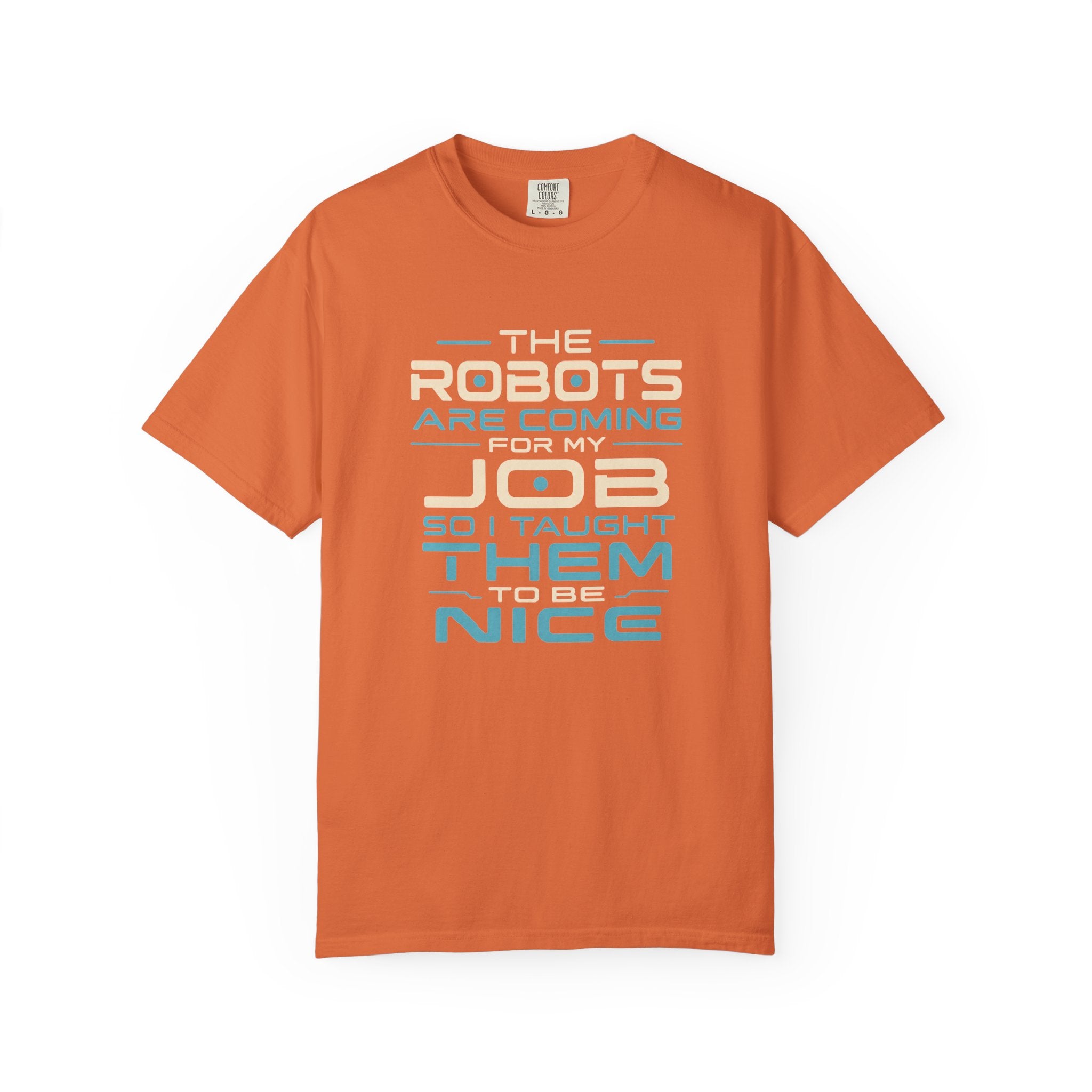An orange short-sleeve crewneck t-shirt with a typographic graphic on the front that reads 'THE ROBOTS ARE COMING FOR MY JOB SO I TAUGHT THEM TO BE NICE' in white and light blue lettering, displayed on a clean white background.