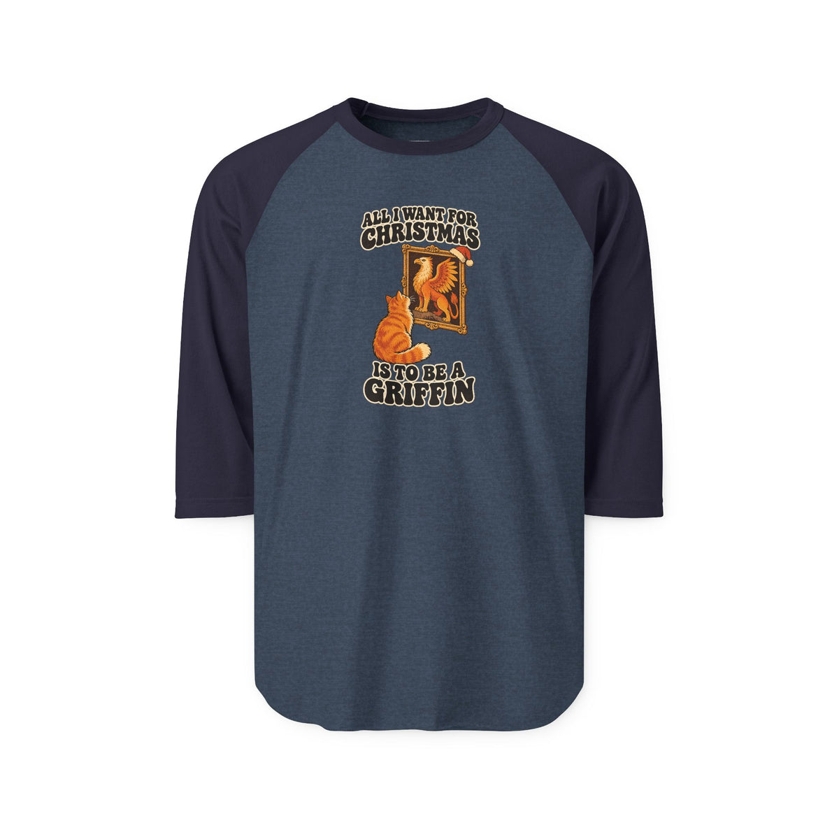 A 3/4 sleeve raglan t-shirt in heathered slate blue with dark navy sleeves and collar. The front features a graphic of an orange cat looking into a mirror with the text 'ALL I WANT FOR CHRISTMAS IS TO BE A GRIFFIN'.