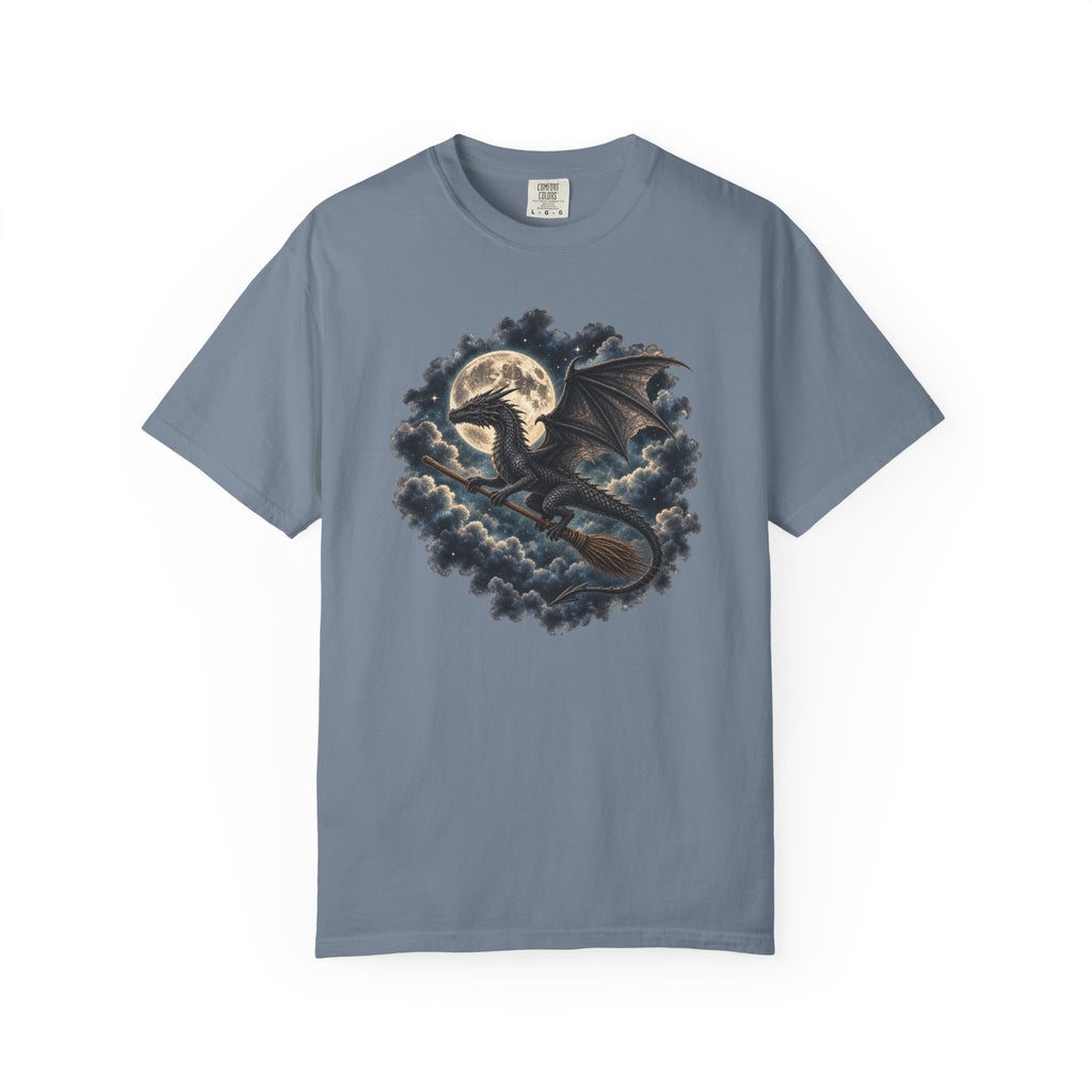 A slate blue short-sleeve crewneck t-shirt featuring a detailed graphic print of a black dragon riding a broomstick in front of a full moon and dark clouds.
