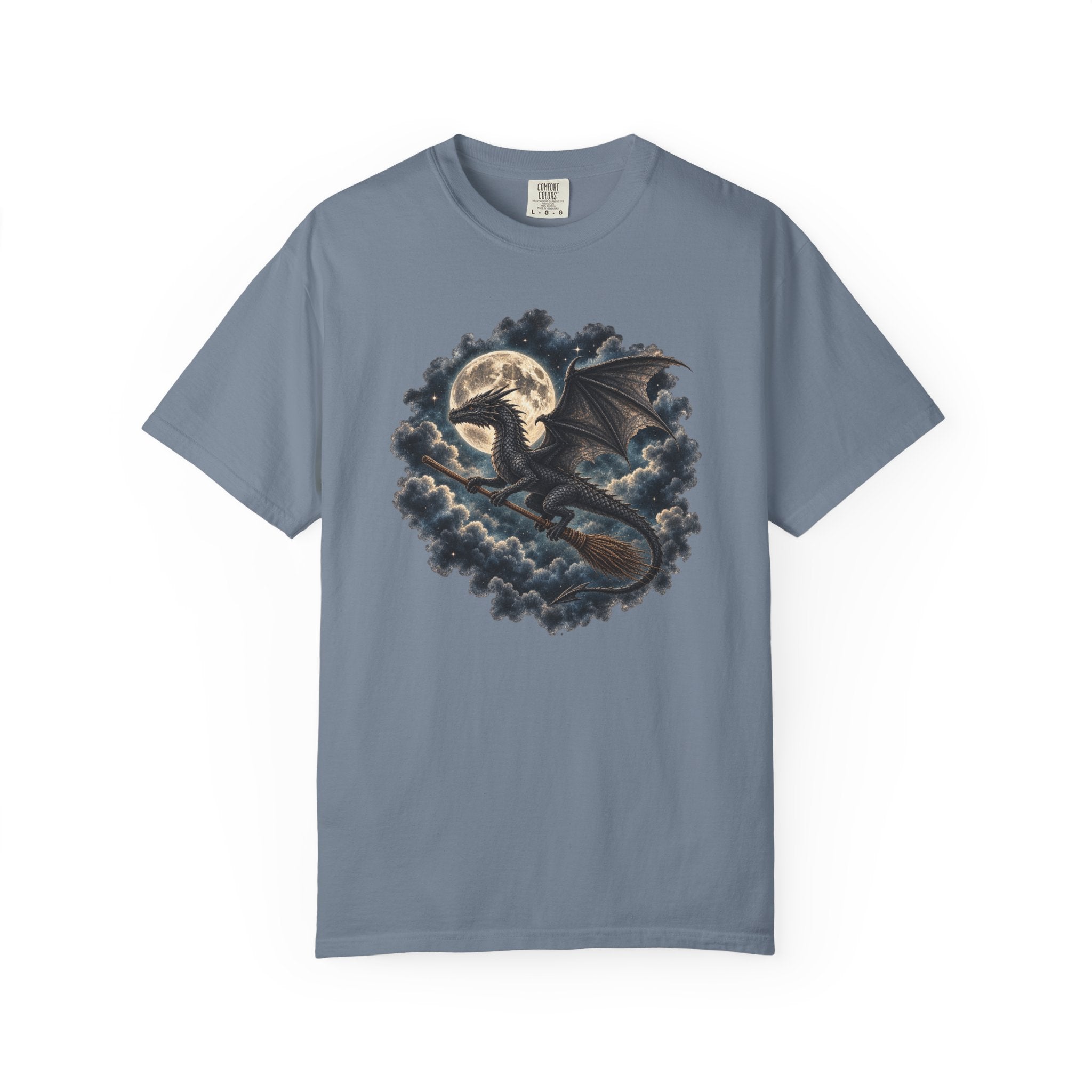 A slate blue short-sleeve crewneck t-shirt featuring a detailed graphic print of a black dragon riding a broomstick in front of a full moon and dark clouds.