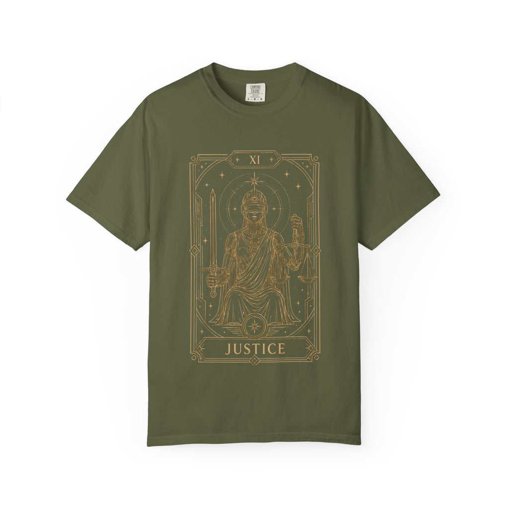 A green Comfort Colors t-shirt featuring Justice from the Future Arcana collection, inspired by the Justice tarot card. A futuristic blindfolded guardian holds a sword and balanced scales within an elegant Art Deco celestial frame rendered in vintage gold line art on a transparent background.
