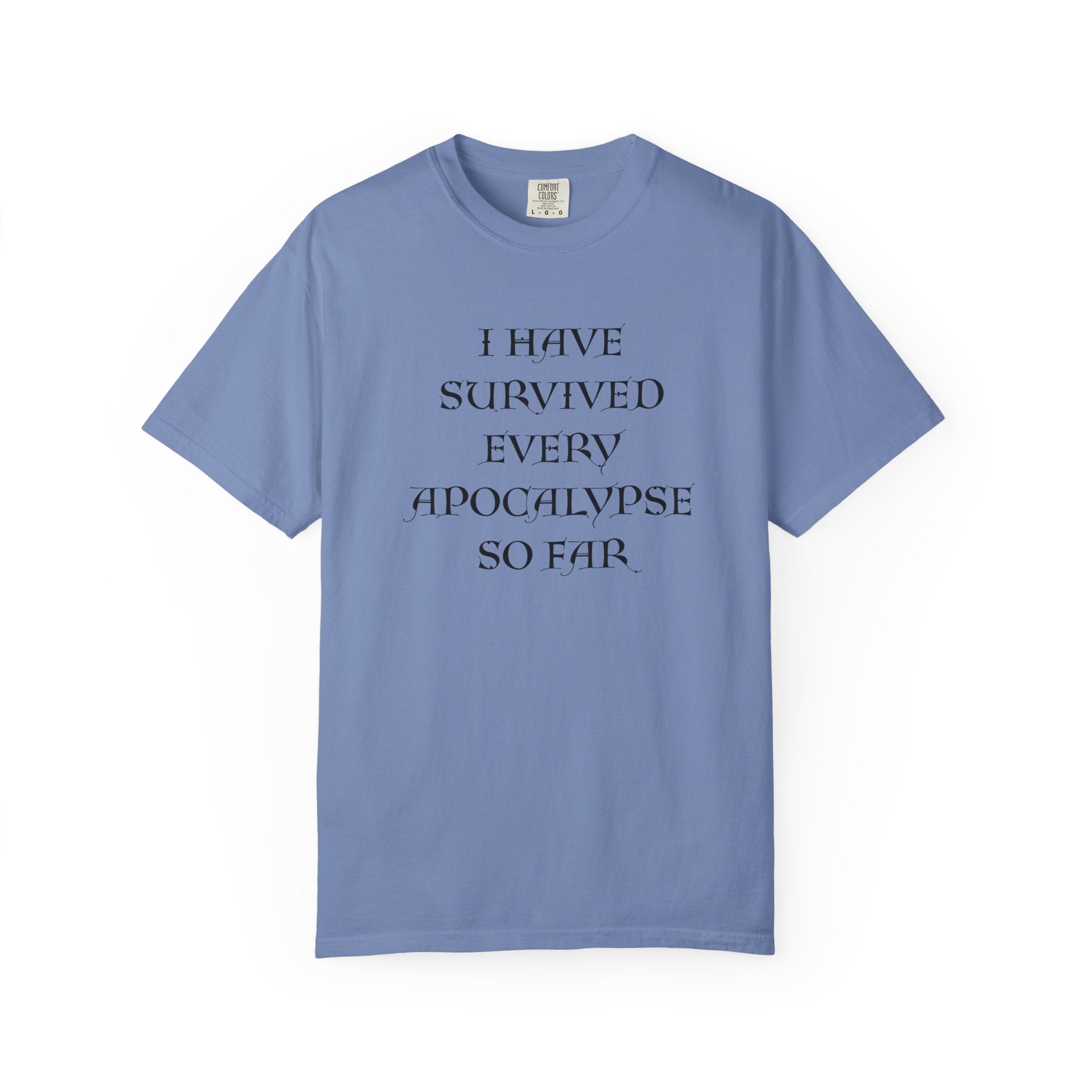 A dark blue short-sleeve crewneck t-shirt with the text 'I HAVE SURVIVED EVERY APOCALYPSE SO FAR.' printed in black serif font on the chest, displayed against a solid white background.