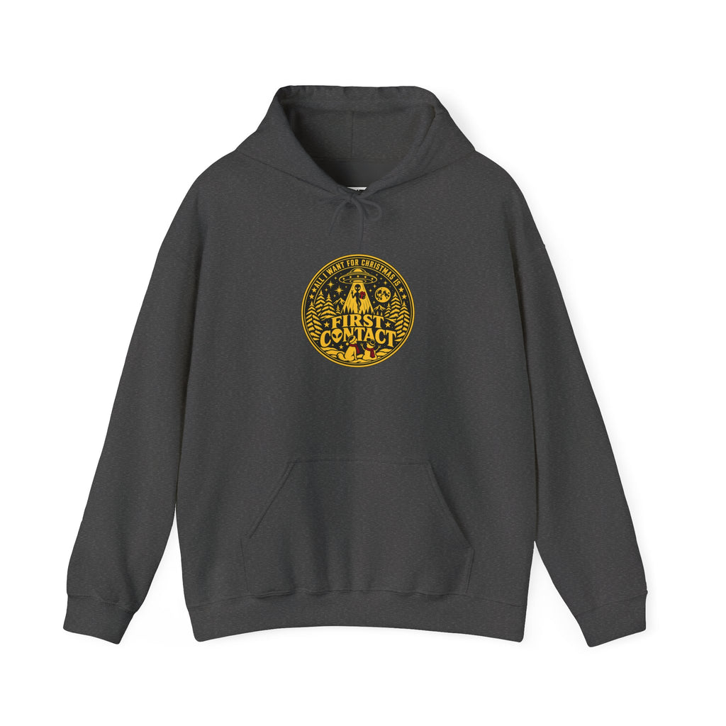 A gray hoodie with  a gold and black circular badge depicting  a dog and a snow man looking up at an alien rising up into a UFO at Christmas, with the words: All I want for Christmas is First Contact' The hoodie is displayed against a white background
