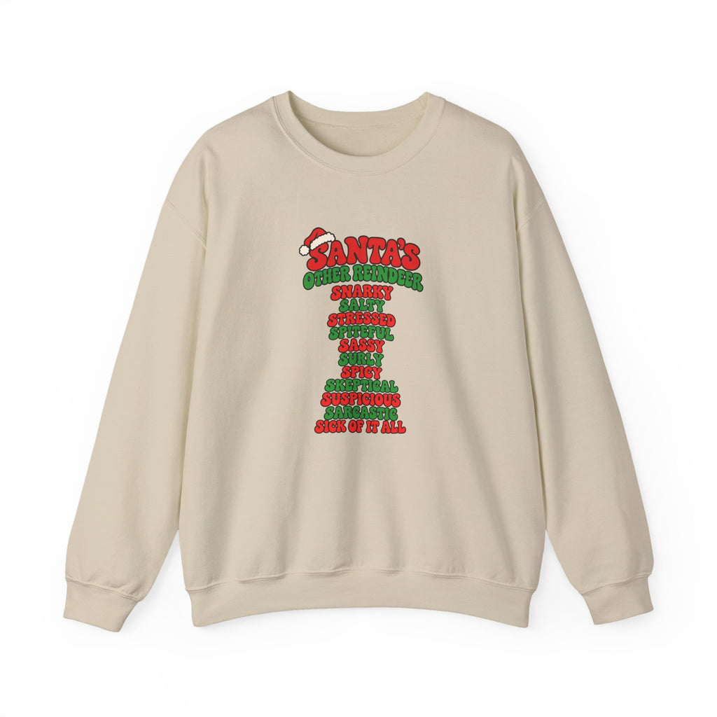 A beige crewneck sweatshirt featuring a red and green graphic print on the front that reads 'SANTA'S OTHER REINDEER' followed by a list of negative qualities in red and green text, shown against a plain white background.