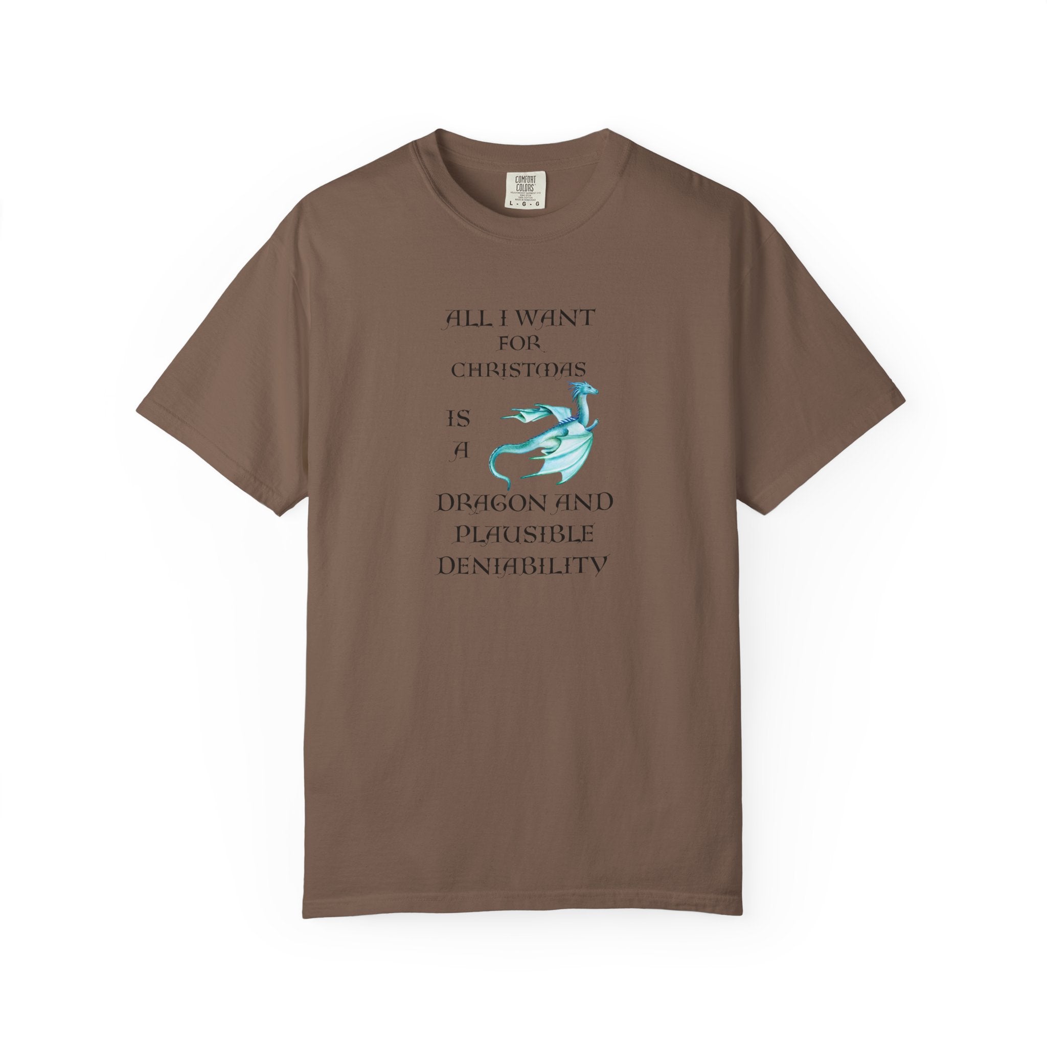 An brown short-sleeve crewneck t-shirt with a graphic print on the front. The graphic features black text reading 'ALL I WANT FOR CHRISTMAS IS A DRAGON AND PLAUSIBLE DENIALABILITY' alongside a light blue dragon illustration.