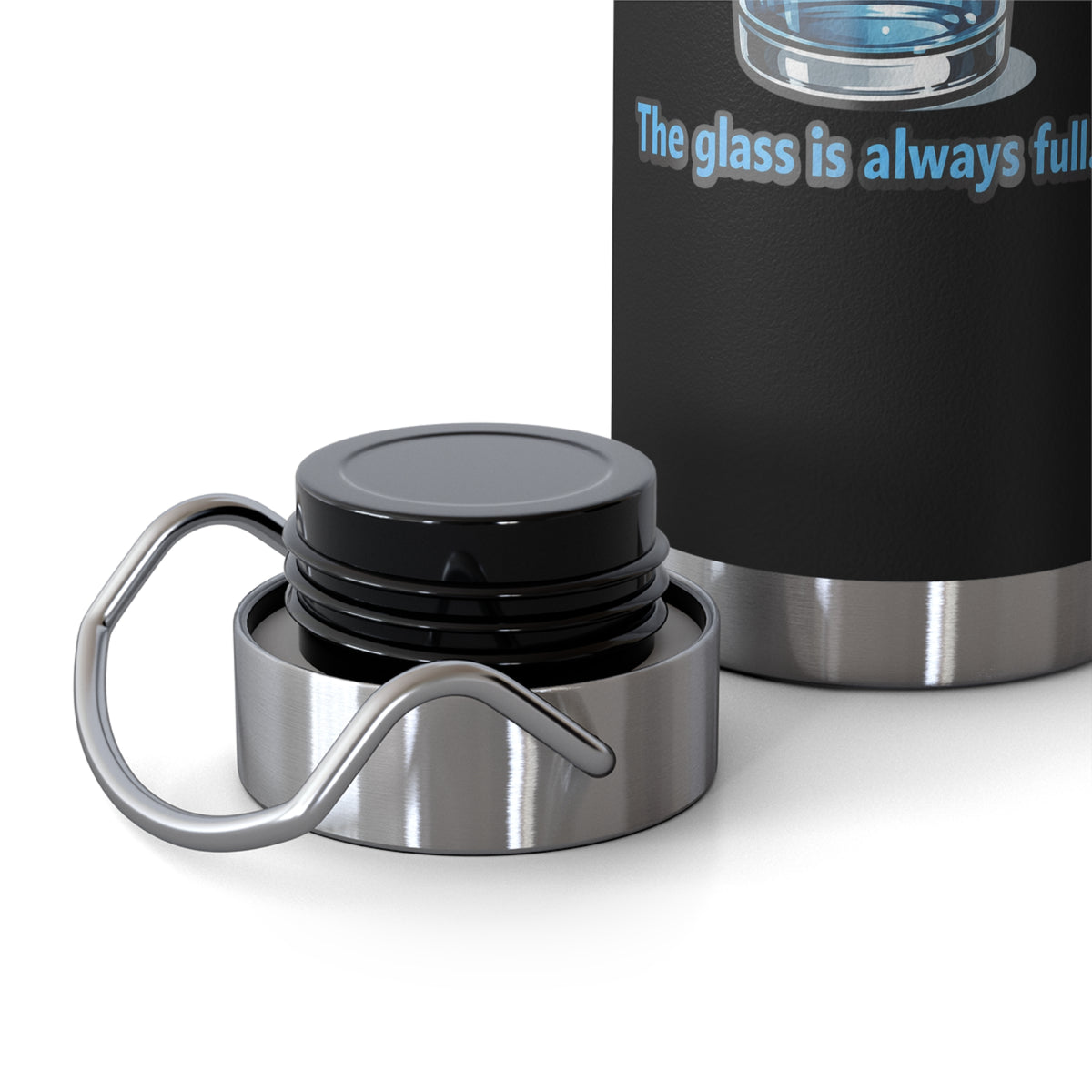 A close-up of a black insulated tumbler with a stainless steel base and a detached metal loop handle on the lid, shown next to the tumbler body. The tumbler has blue text reading 'The glass is always full.