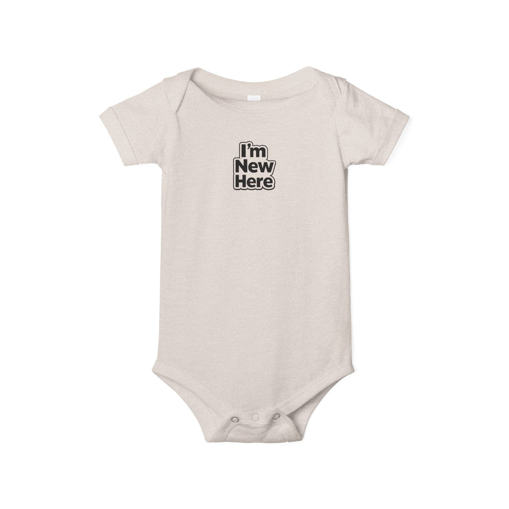 Beige baby onesie with 'I'm New Here' text on a white background