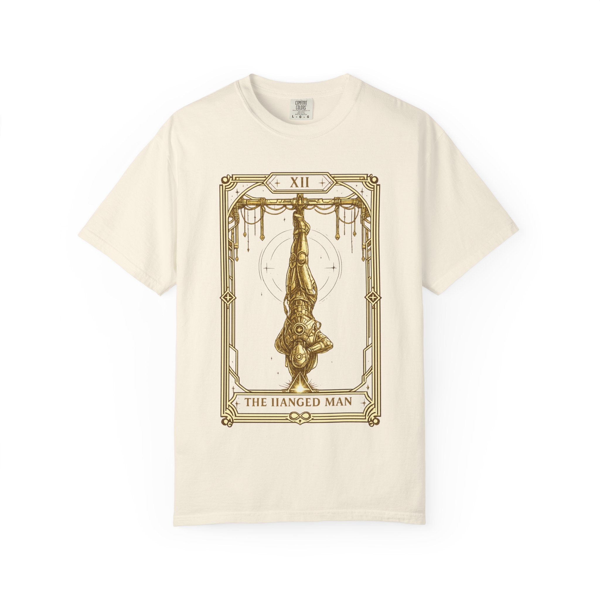 a beige t-shirt featuring The Hanged Man from the Future Arcana collection, inspired by The Hanged Man tarot card. A futuristic explorer hangs suspended upside down within an elegant Art Deco celestial frame, illustrated in vintage gold line art on a transparent background.