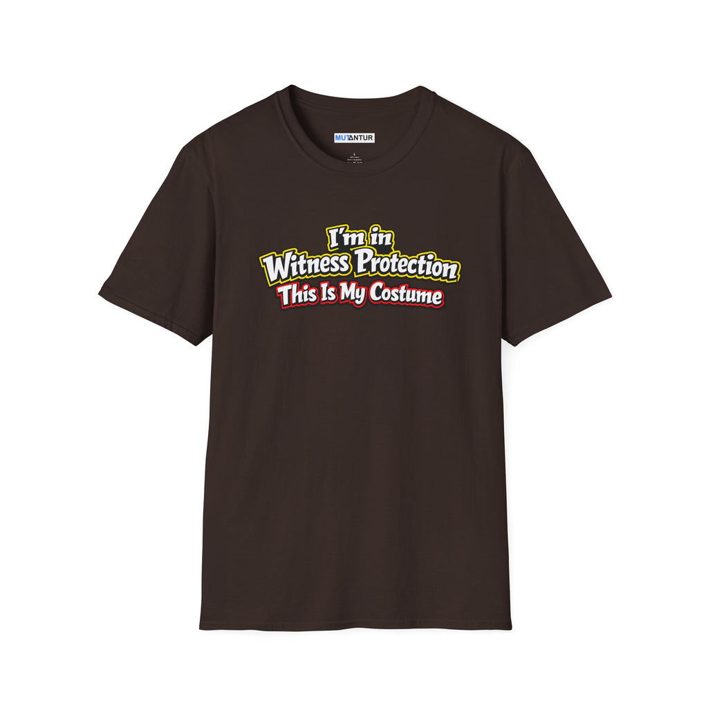 Brown short-sleeve crewneck t-shirt featuring a graphic on the chest that reads 'I'm in Witness Protection This Is My Costume' in a stylized, vintage font with green, yellow, and red accents