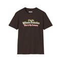 Brown short-sleeve crewneck t-shirt featuring a graphic on the chest that reads 'I'm in Witness Protection This Is My Costume' in a stylized, vintage font with green, yellow, and red accents