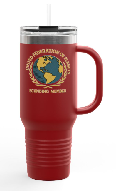 A red insulated travel tumbler with a handle, clear lid, and straw. The front features a gold, blue, and white United Federation of Planets emblem with the text 'UNITED FEDERATION OF PLANETS' and 'FOUNDING MEMBER'.